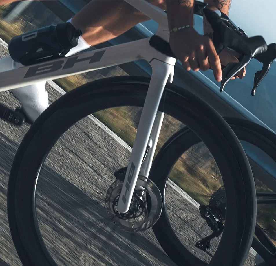 Close-up of the fork, disc brake and down tube of a white BH Ultralight
